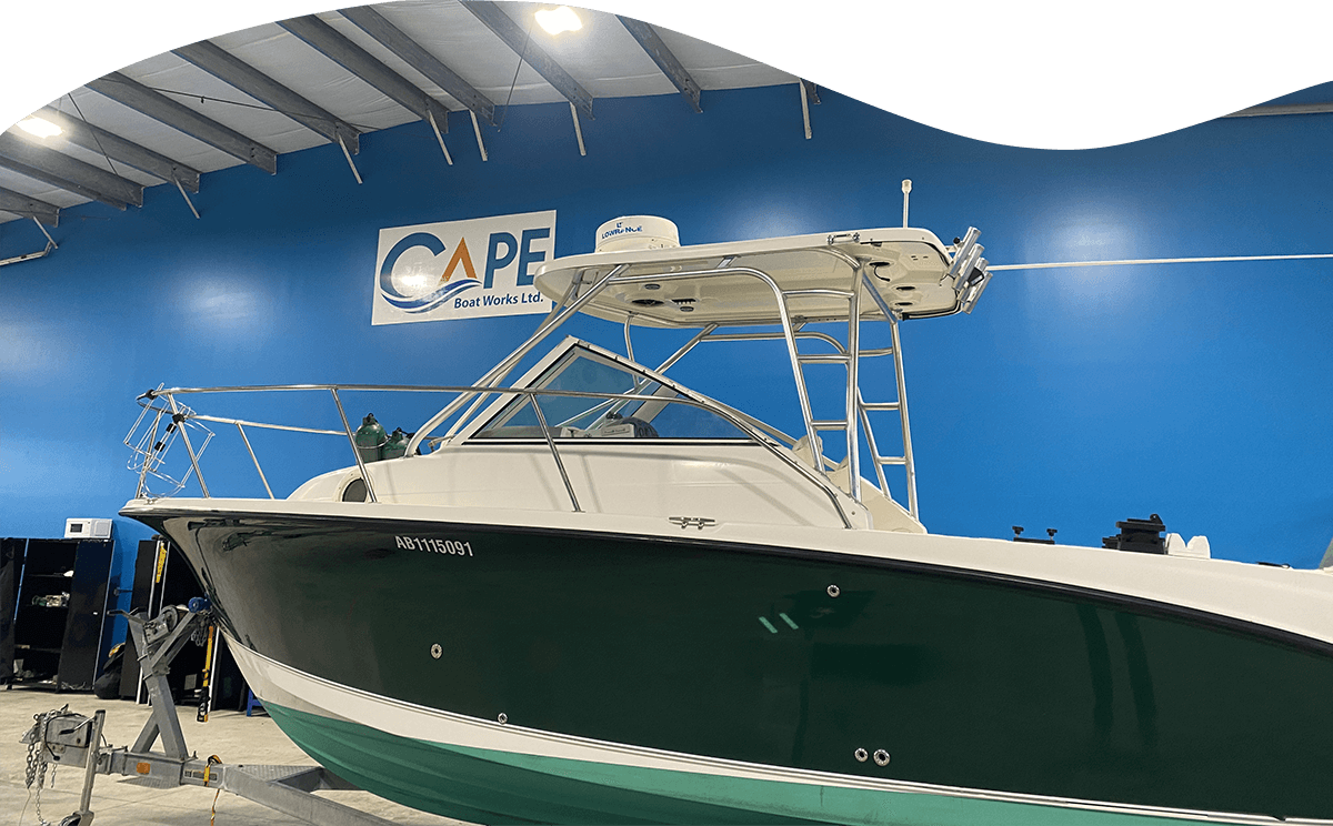 Cape Boat Works Boat inside shop with blue walls and logo