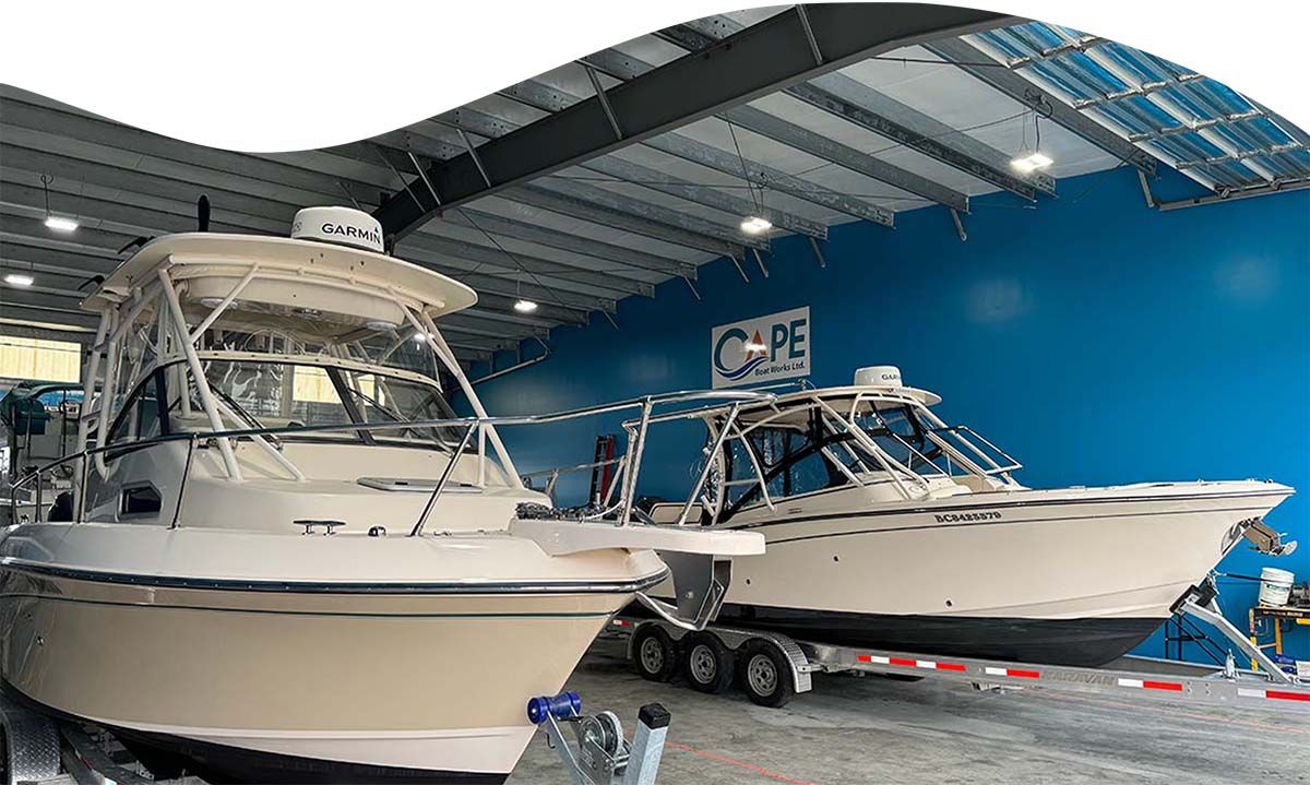 Boat inside Cape Boat Works shop with blue walls in behind