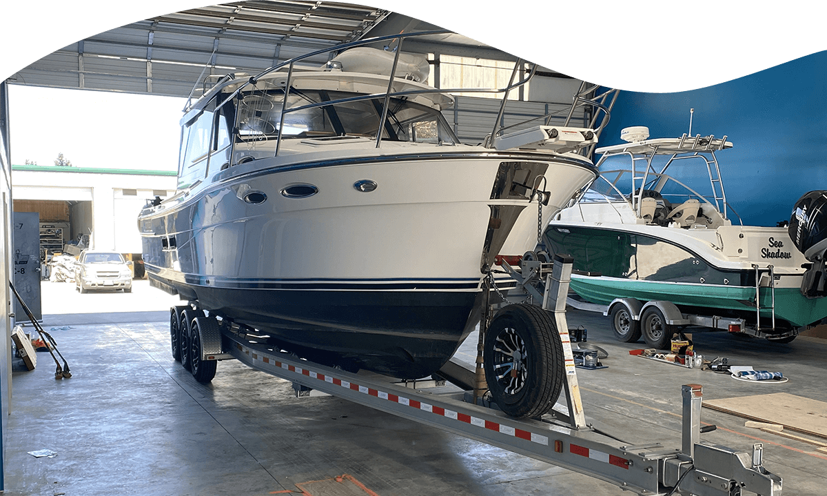 Boat being worked on inside Cape Boat Work's shop